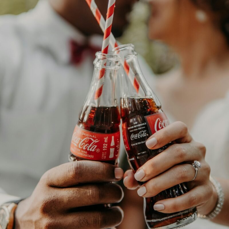 person holding coca cola bottle